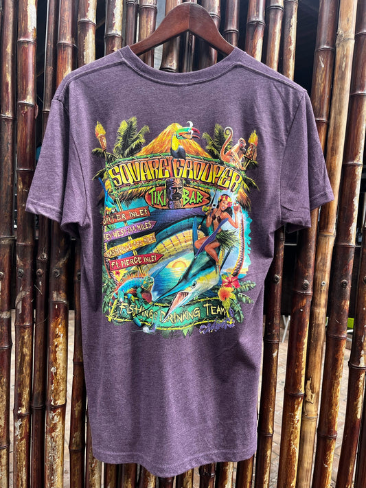 A purple short-sleeved t-shirt with a graphic print of a surfer and tropical elements, and the text 'Square Grouper Fishing & Drinking Team'.